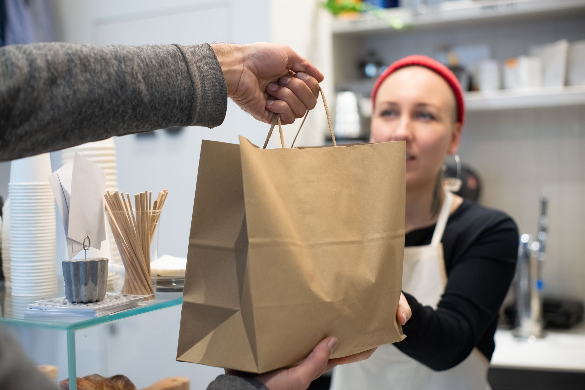 A takeaway order being handed to a customer at the counter