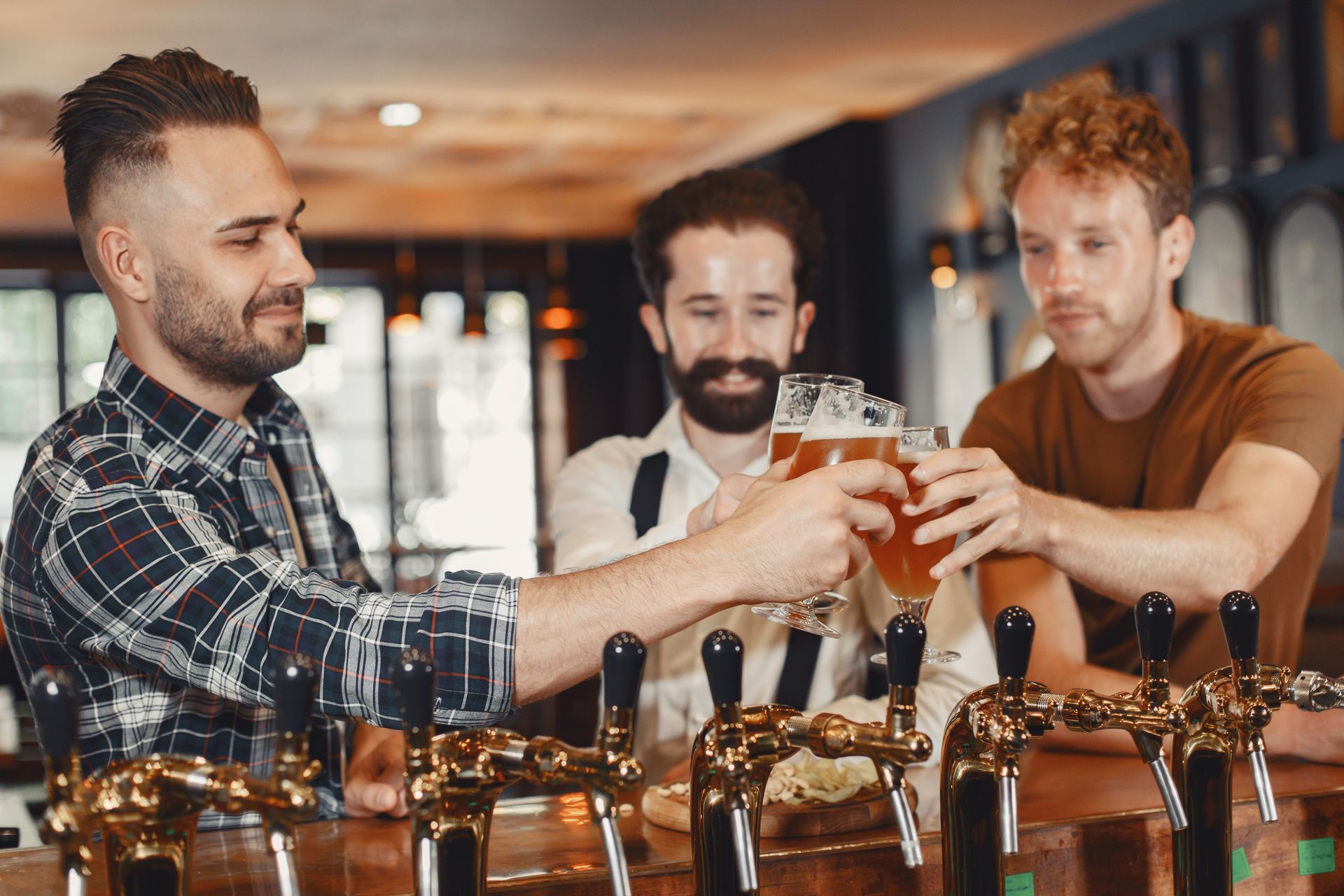 Friends raising glasses at the bar while service runs smoothly