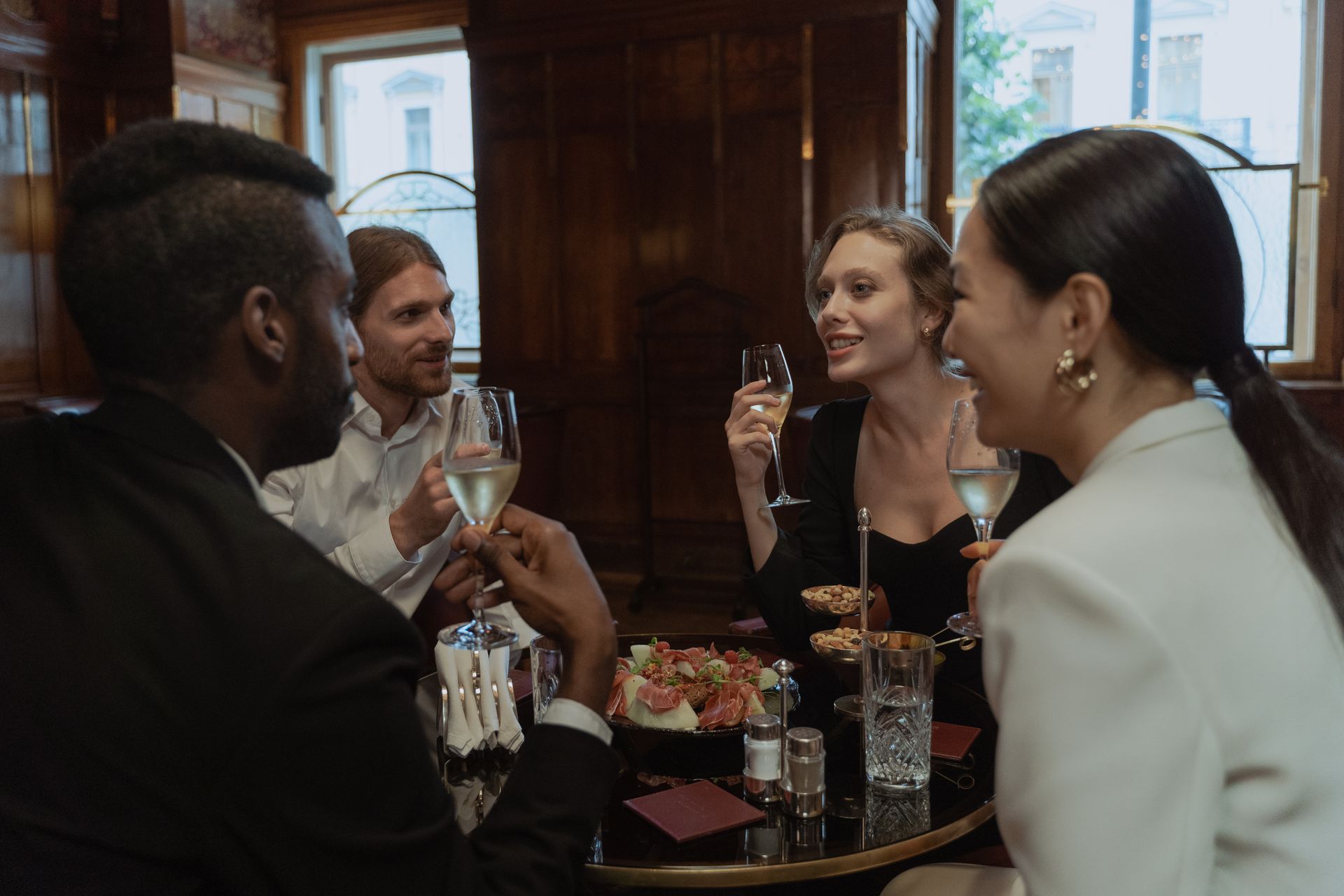Diners raising their glasses at a restaurant table